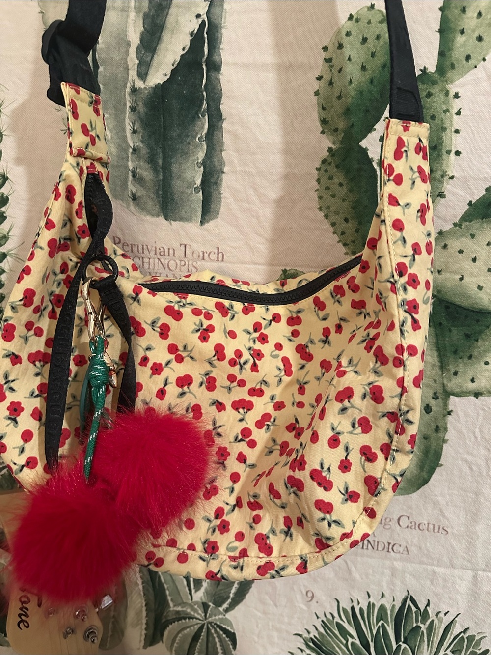Urban Outfitters Exclusive BAGGU Red Cherry Print atop a pastel yellow
